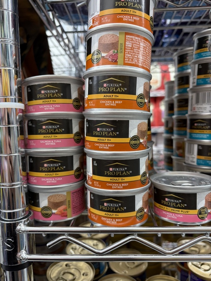 Purina Pro Plan Adult 11+ canned entrees on a store shelf